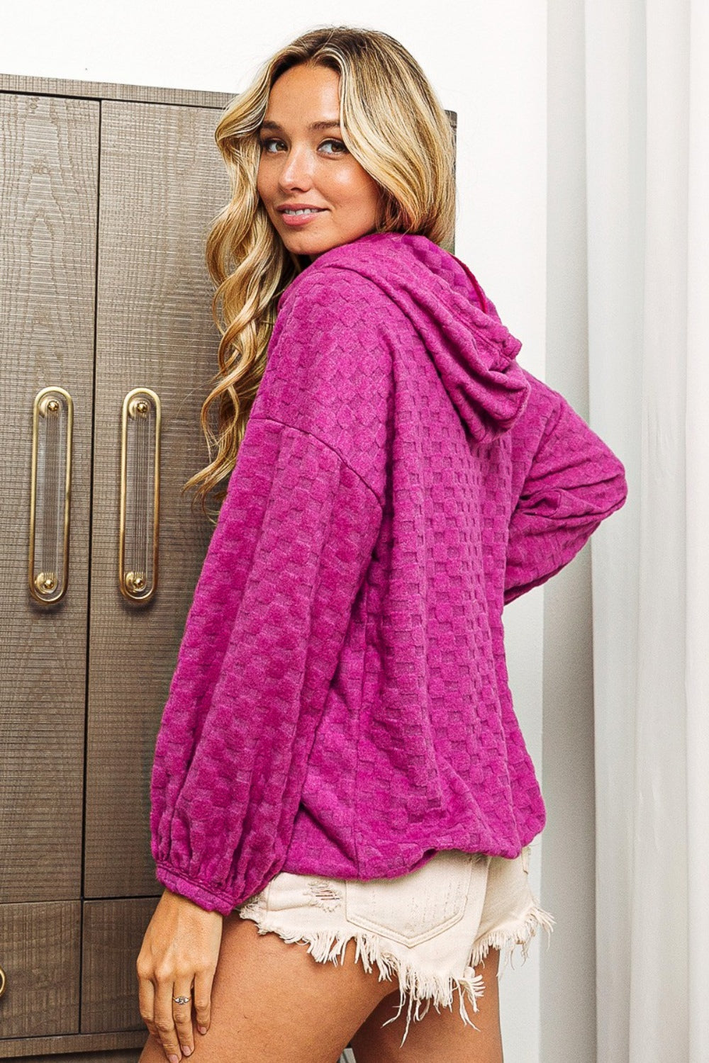 Side/Back view of model wearing a Magenta BiBi Brushed Checker Drawstring Women's Hoodie