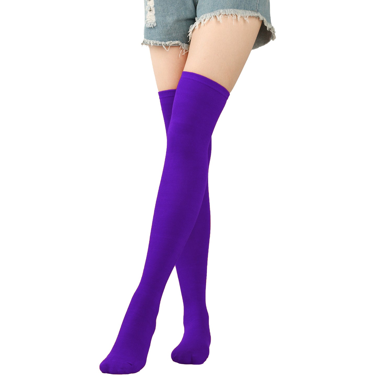 Purple knee-high socks worn with denim shorts on a white background