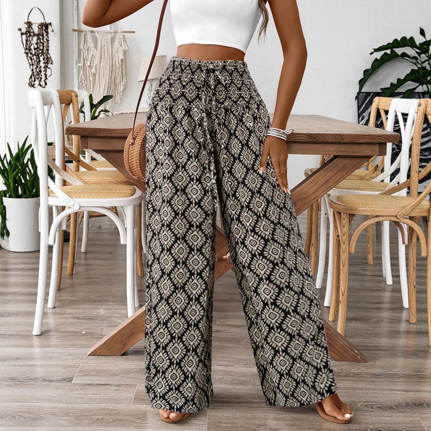 Person wearing patterned pants in a dining room setting