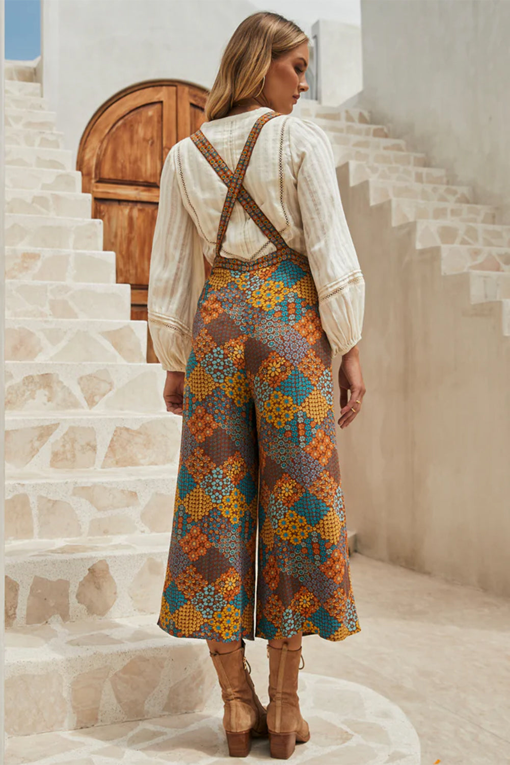 Back view of a model wearing Retro-Modern Hippie Floral Overalls