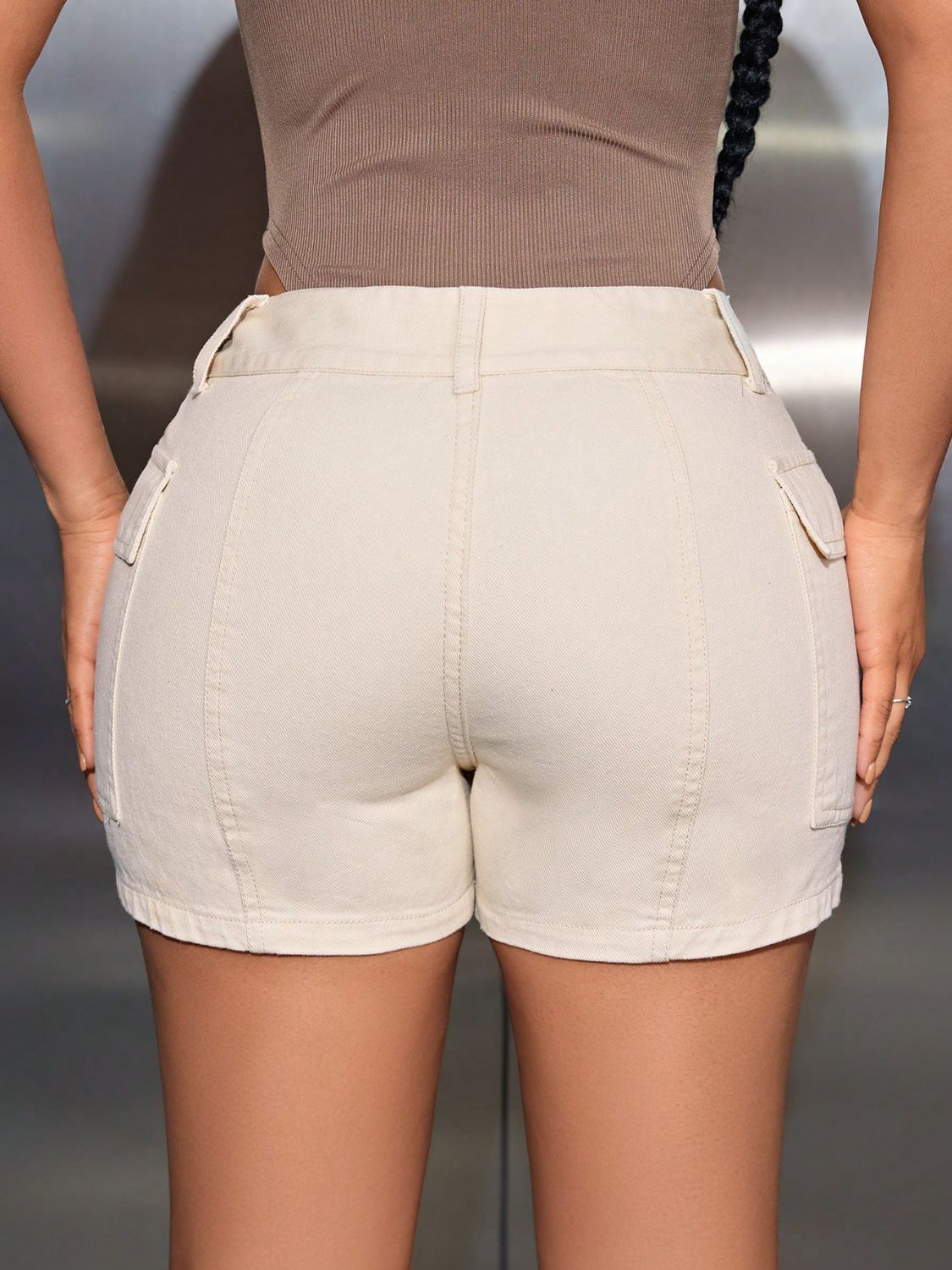 Back view of a model wearing Chic Women's Mid-Rise Waist Shorts with Cargo-Style Pockets