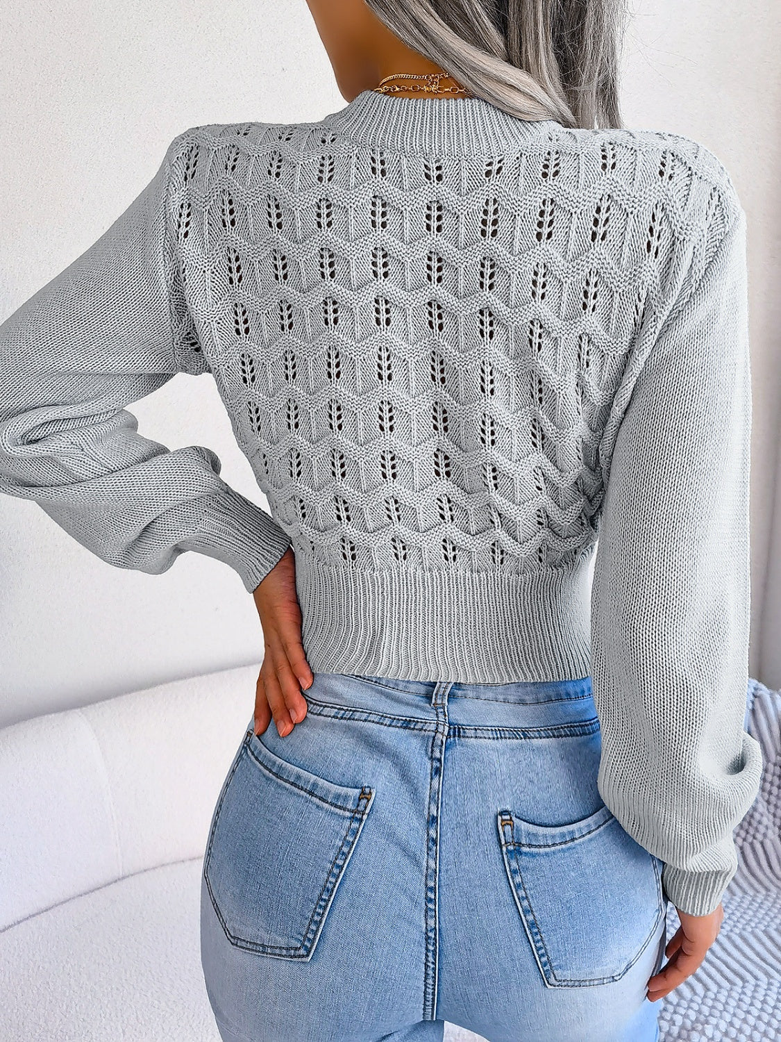 Back view of Women's Exquisitely Contemporary Openwork Mock Neck Cropped Grey Sweater