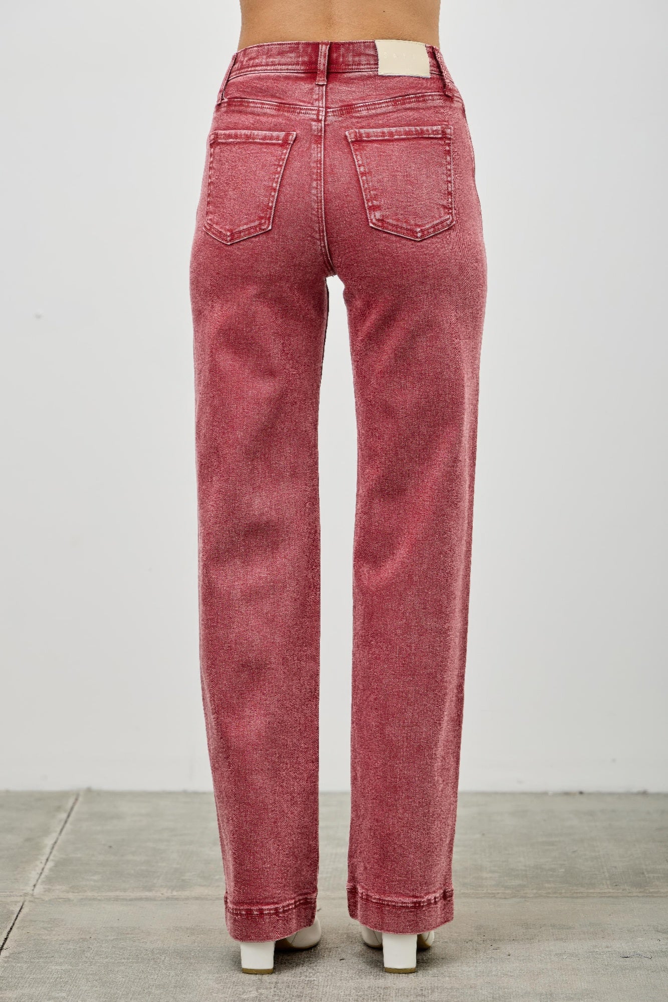 Red jeans worn by a person rear fit view