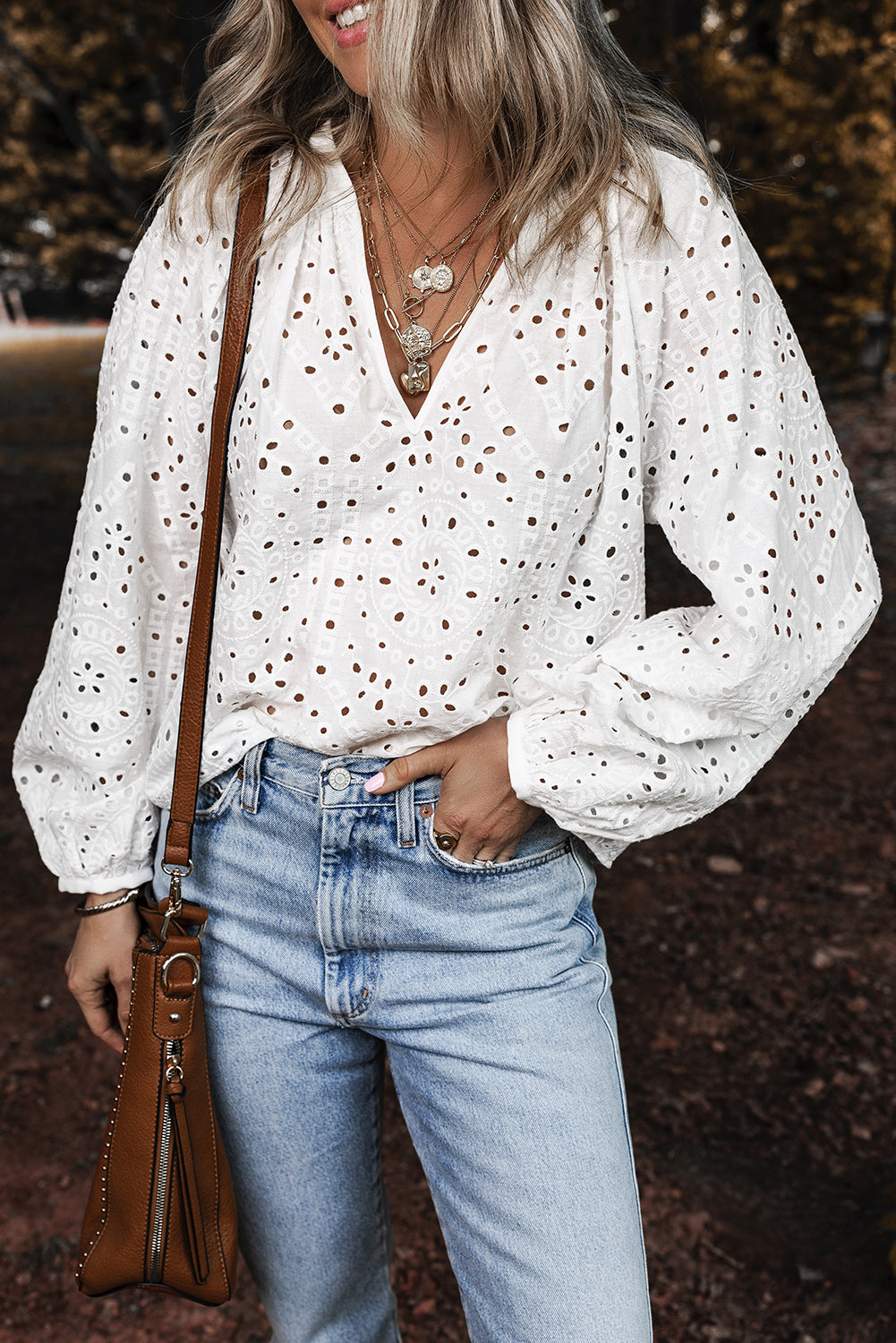 Model wearing a Chic White Eyelet Embroidered V Neck Blouse
