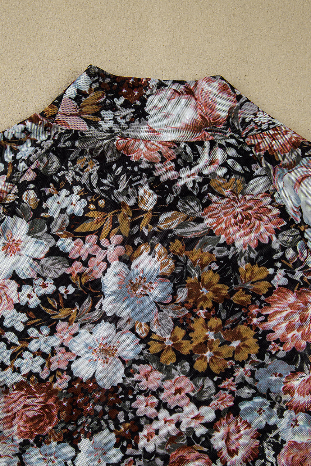 Close-up of the floral pattern on the top, showcasing its design.