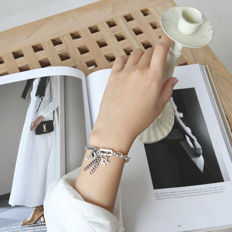 Model wearing Curb Chain Star Key Tassels 925 Sterling Silver Bracelet