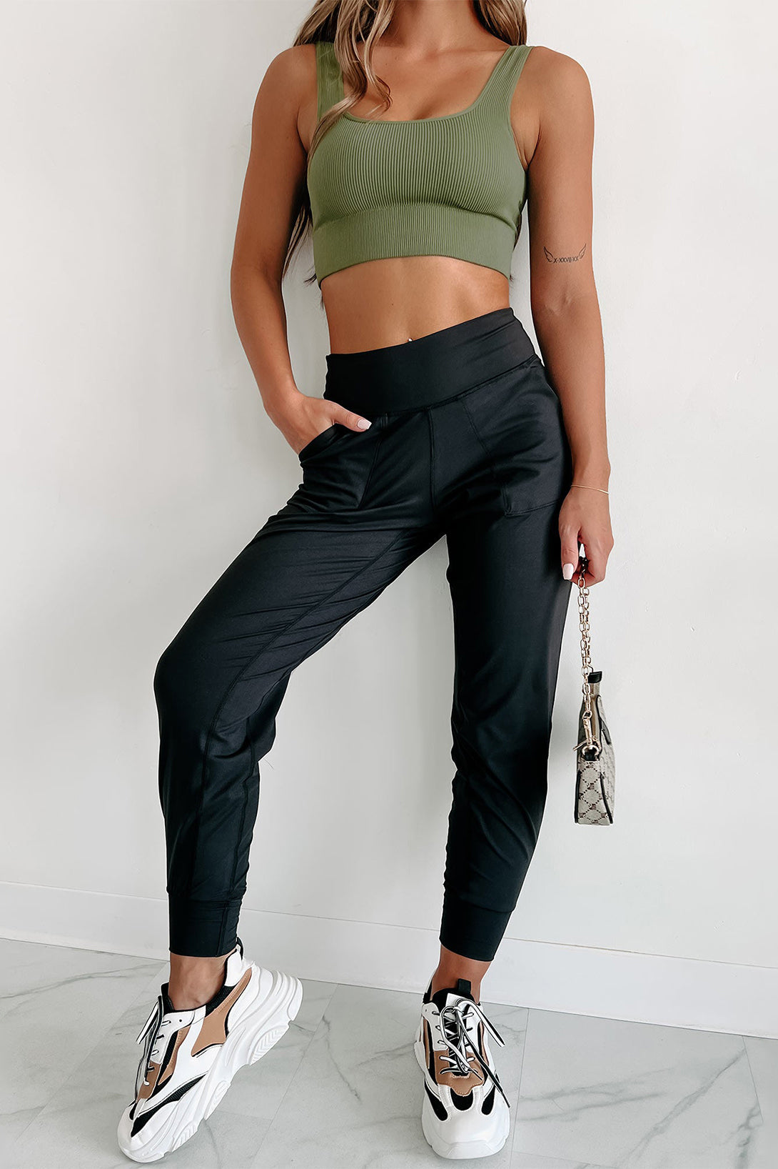 Model wearing Chic Black Exposed Seam High Waist Pocketed Women’s Joggers