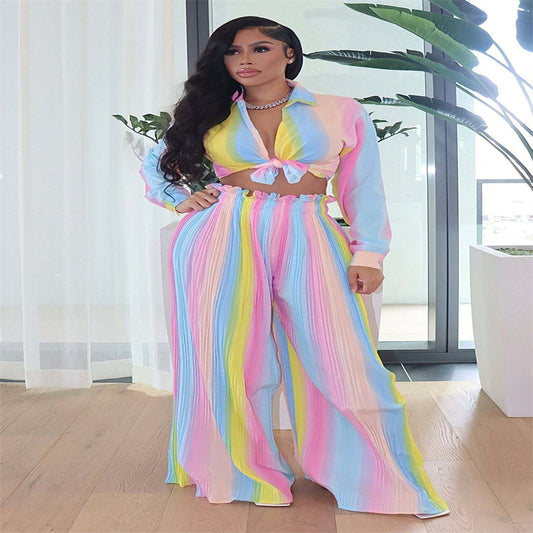 Model in pastel rainbow tie-front crop top and high-waist pleated wide-leg pants, featuring vibrant multicolor stripes that radiate confidence and originality.