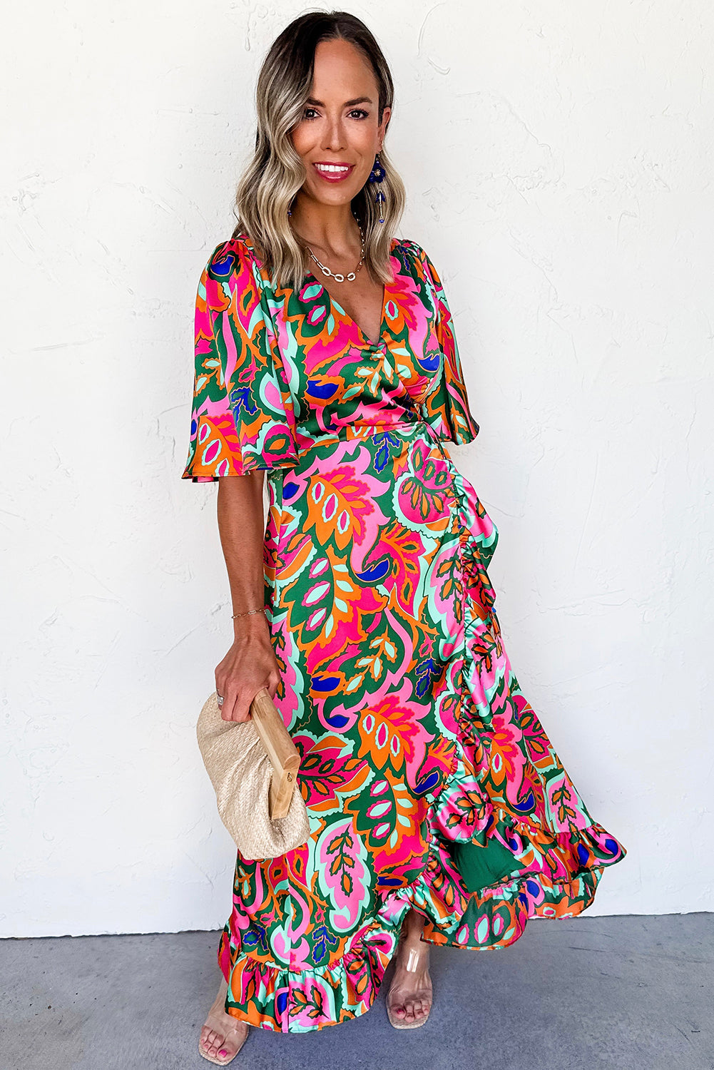 Woman wearing a colorful floral dress against a white background