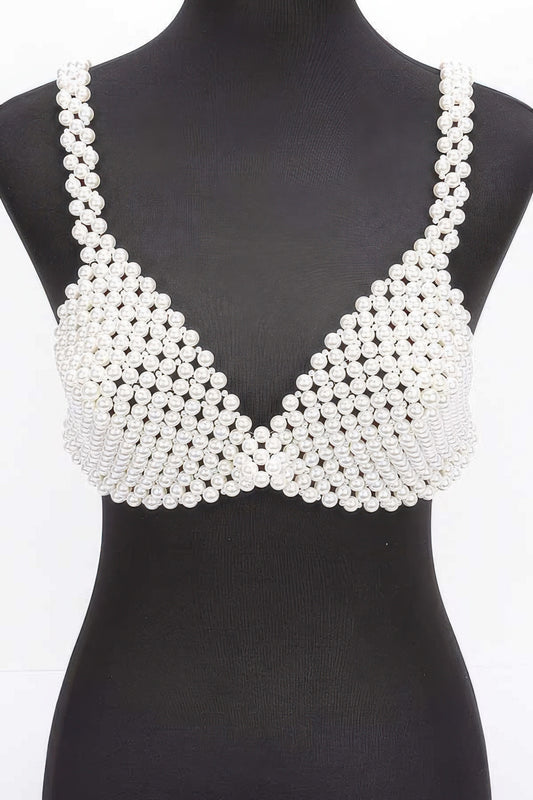 Pearl-studded bralette on a mannequin against a white background