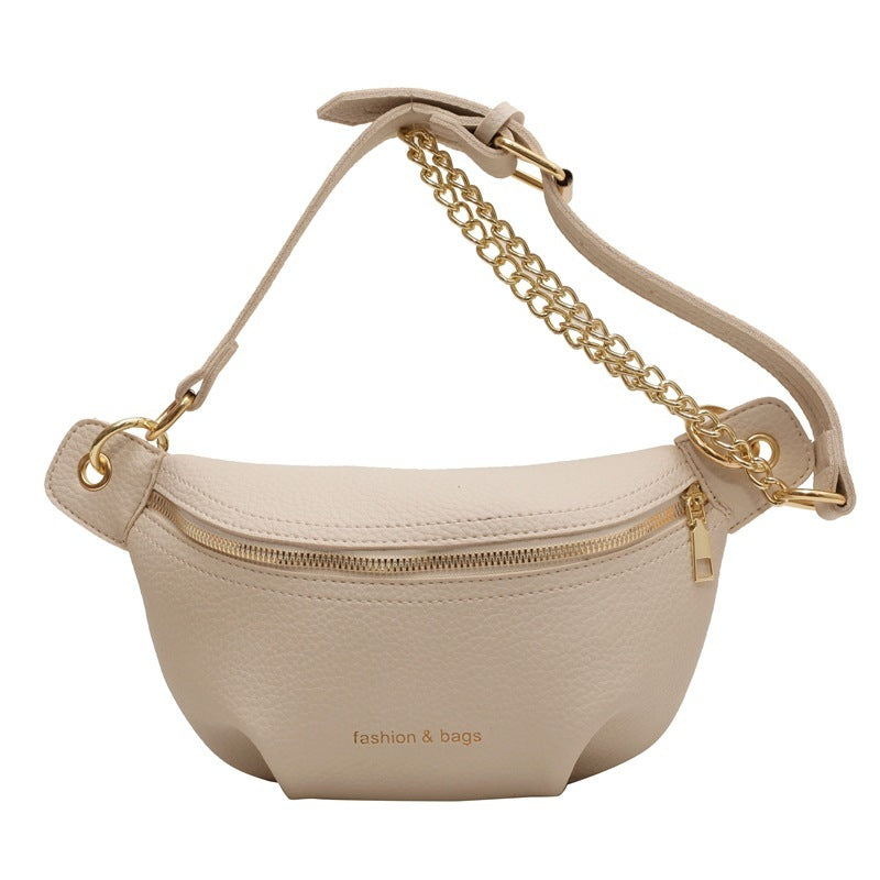 Beige waist bag with gold chain strap on a white background