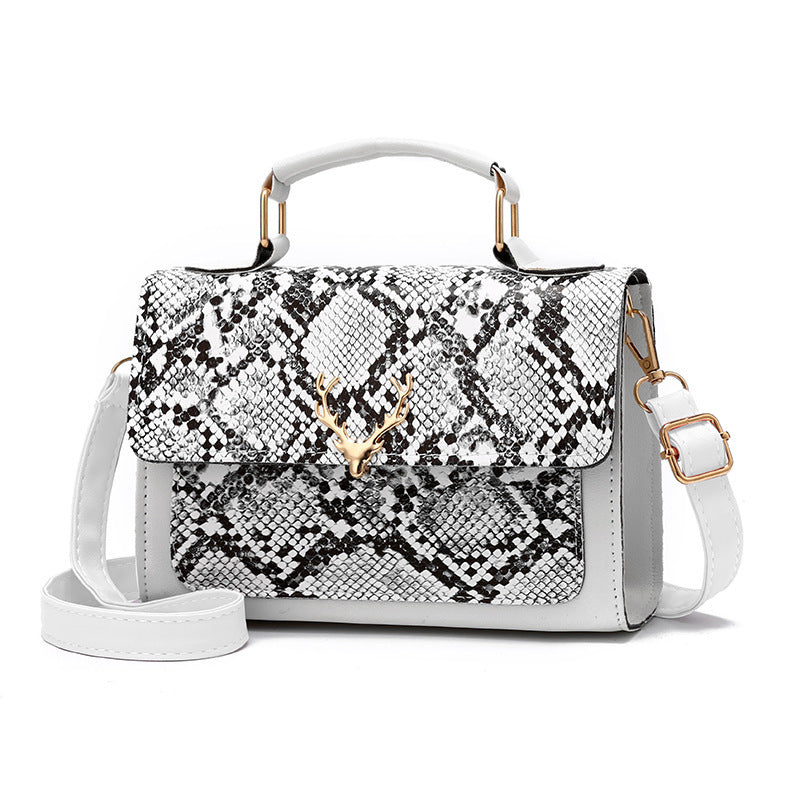 Handbag with snake print and white body on a white background