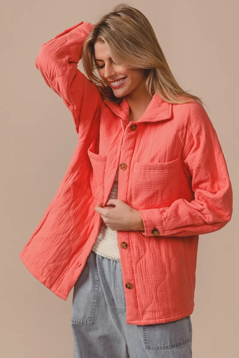 Woman wearing a coral jacket with a beige background 4