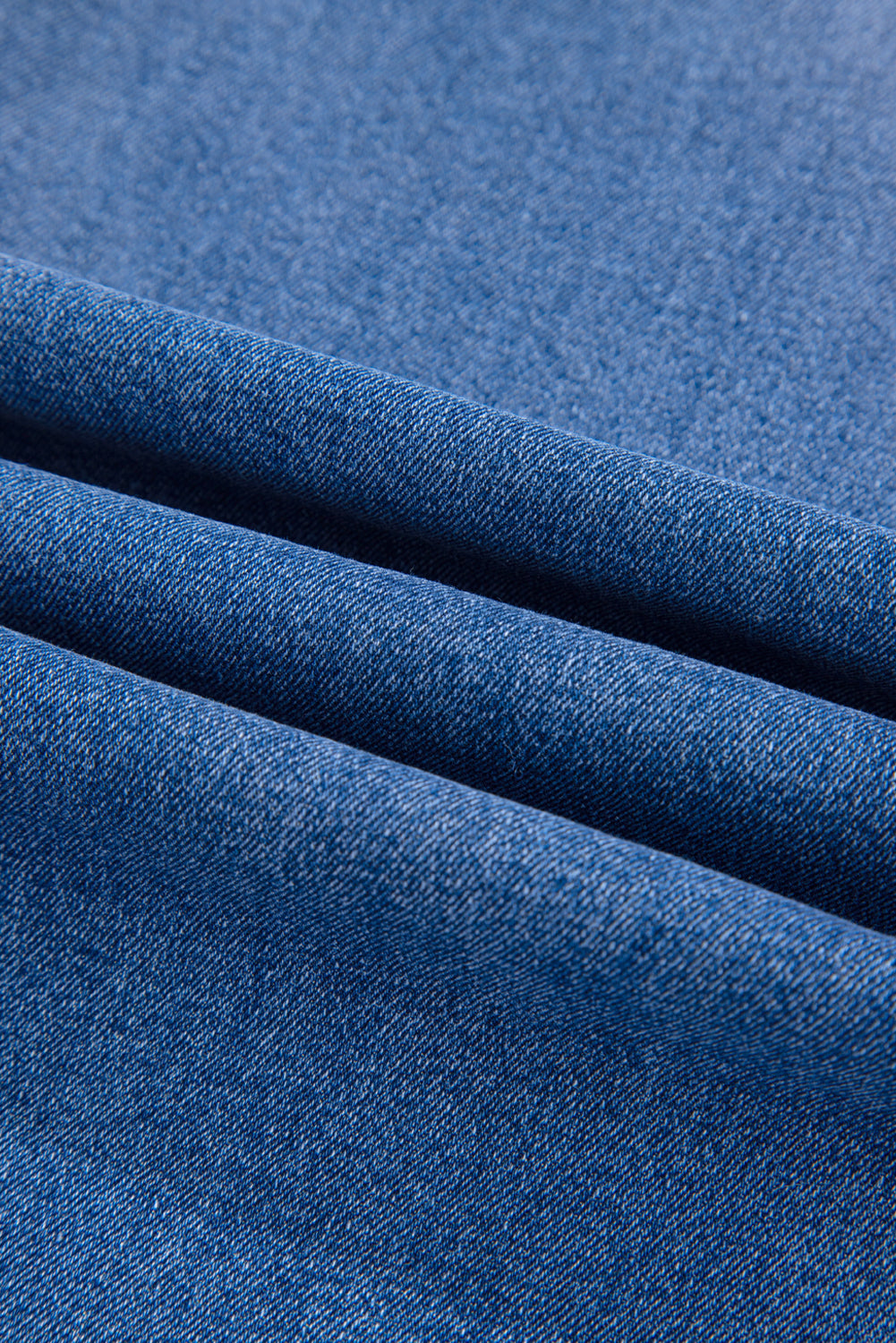 Close-up of blue denim fabric with a textured pattern
