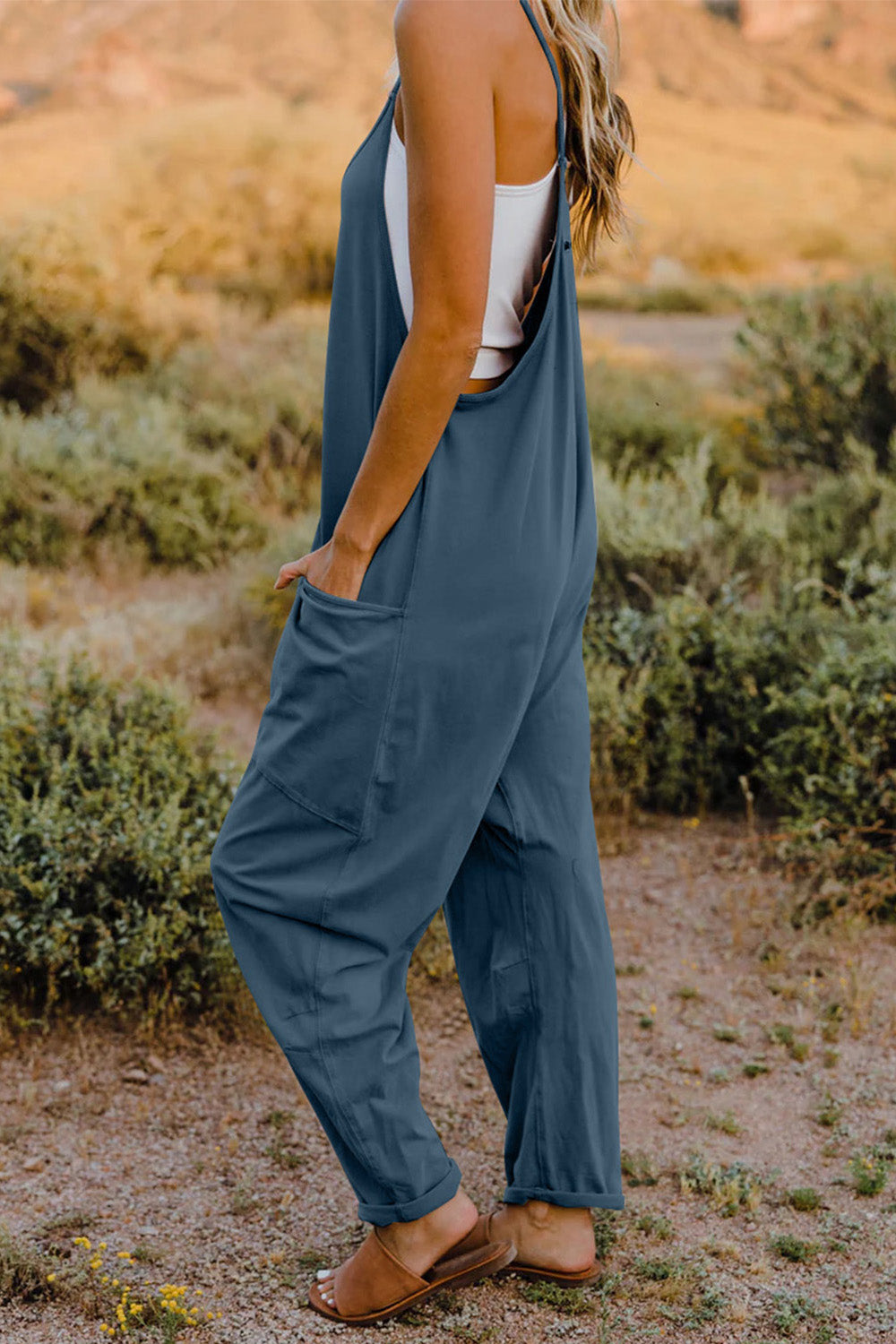 This Women's V-Neck Sleeveless Jumpsuit with Pocket is perfect for any occasion! Show off your style with a sleek silhouette while keeping your stuff handy with the pocket. Nothing like looking cool while staying organized!