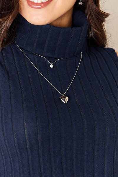 Model wearing Navy Basic Bae Women's Full Size Ribbed Turtleneck Tank close up view