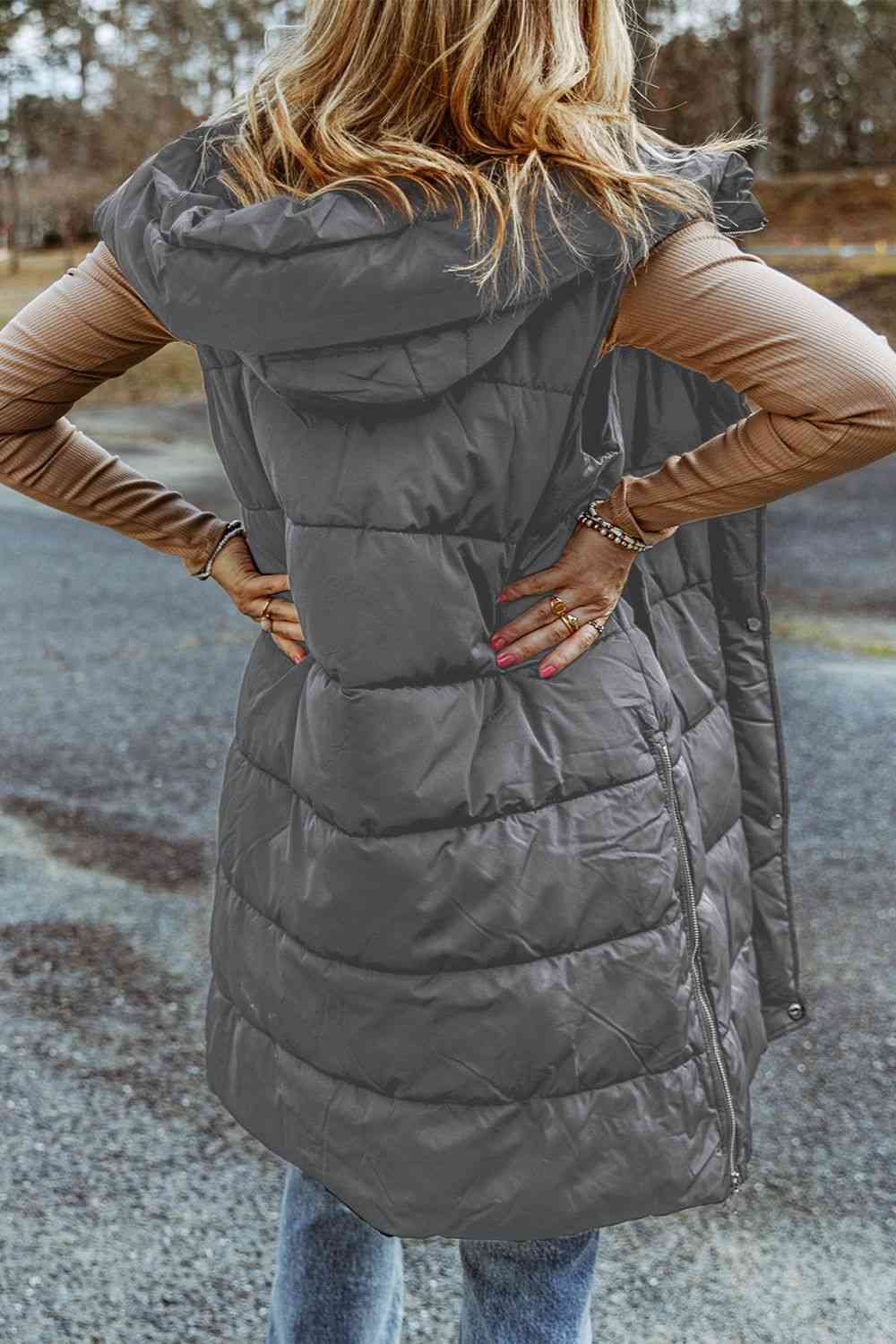 Back view a model wearing a Charcoal Women's Posh Sleeveless Longline Hooded Puffer Vest