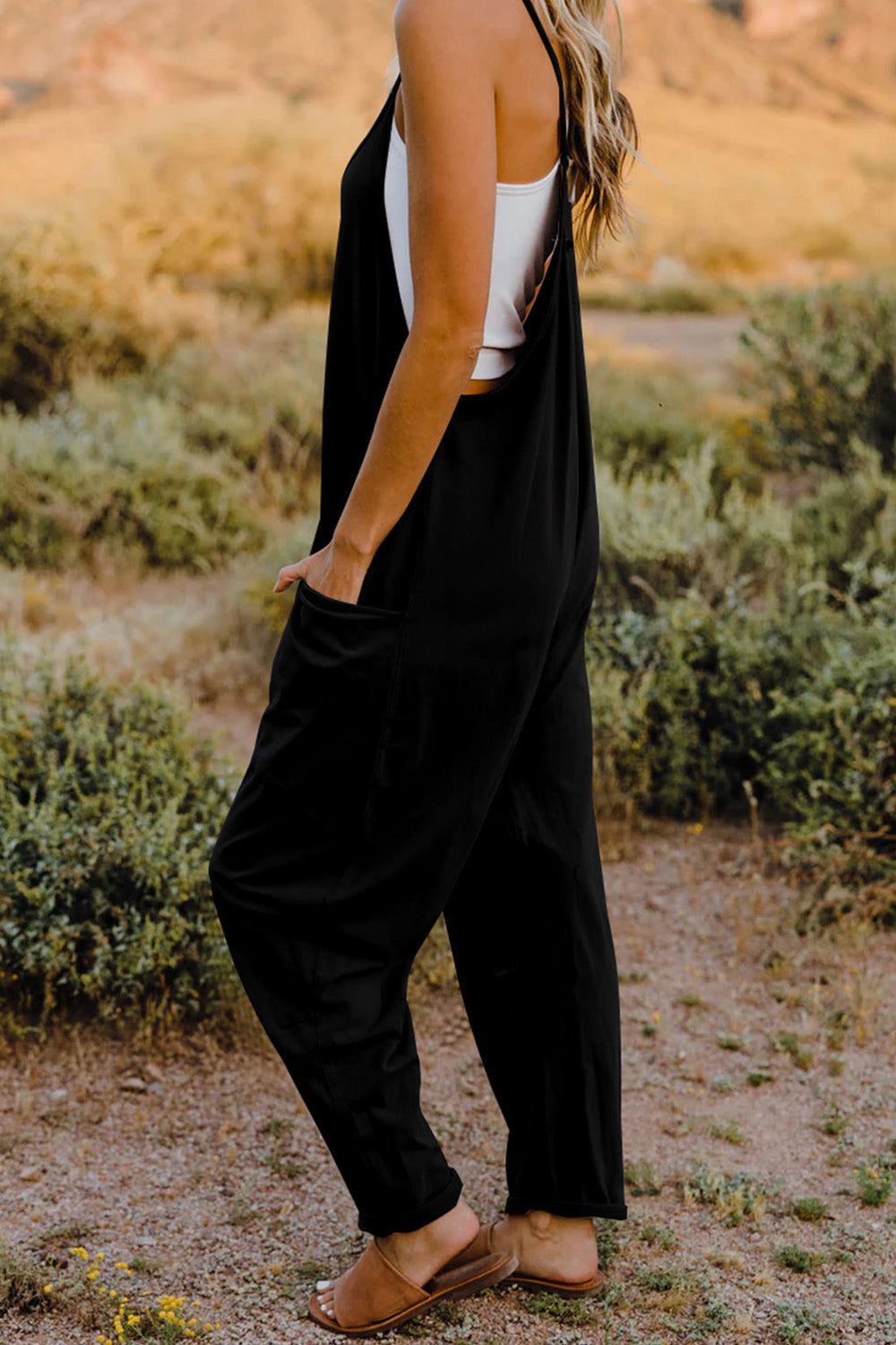 This Women's V-Neck Sleeveless Jumpsuit with Pocket is perfect for any occasion! Show off your style with a sleek silhouette while keeping your stuff handy with the pocket. Nothing like looking cool while staying organized!
