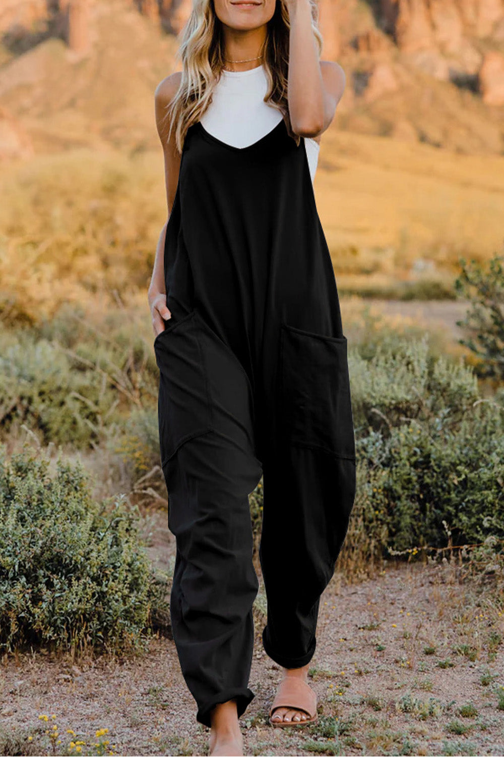This Women's V-Neck Sleeveless Jumpsuit with Pocket is perfect for any occasion! Show off your style with a sleek silhouette while keeping your stuff handy with the pocket. Nothing like looking cool while staying organized!