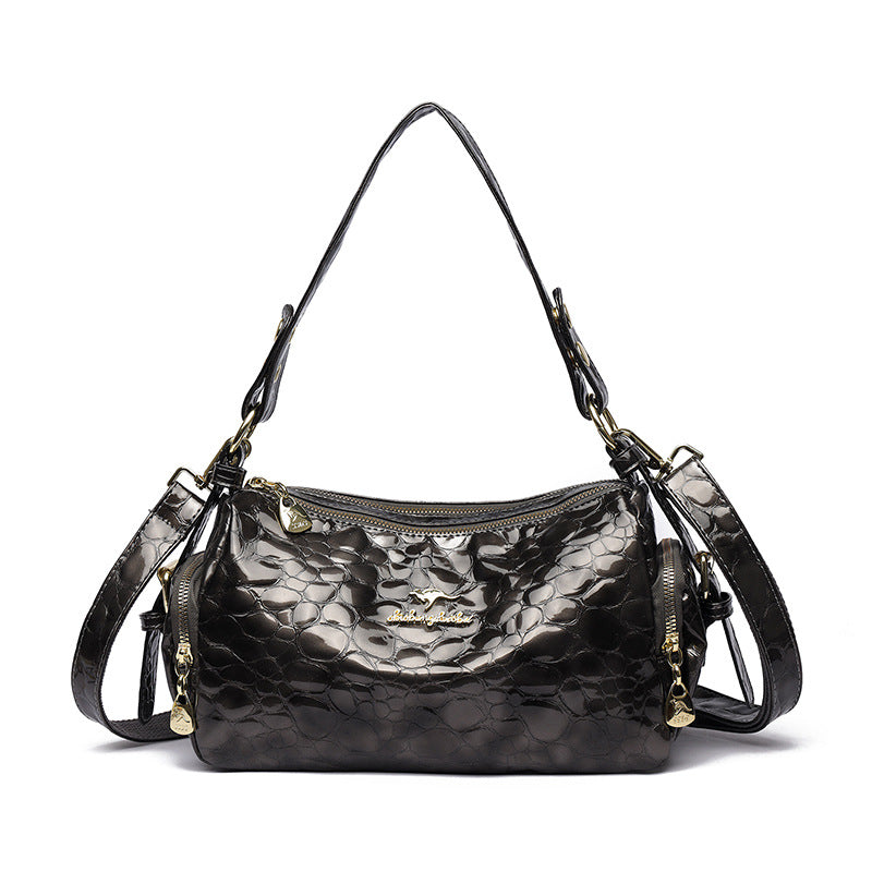 Black handbag with metallic pattern on a white background