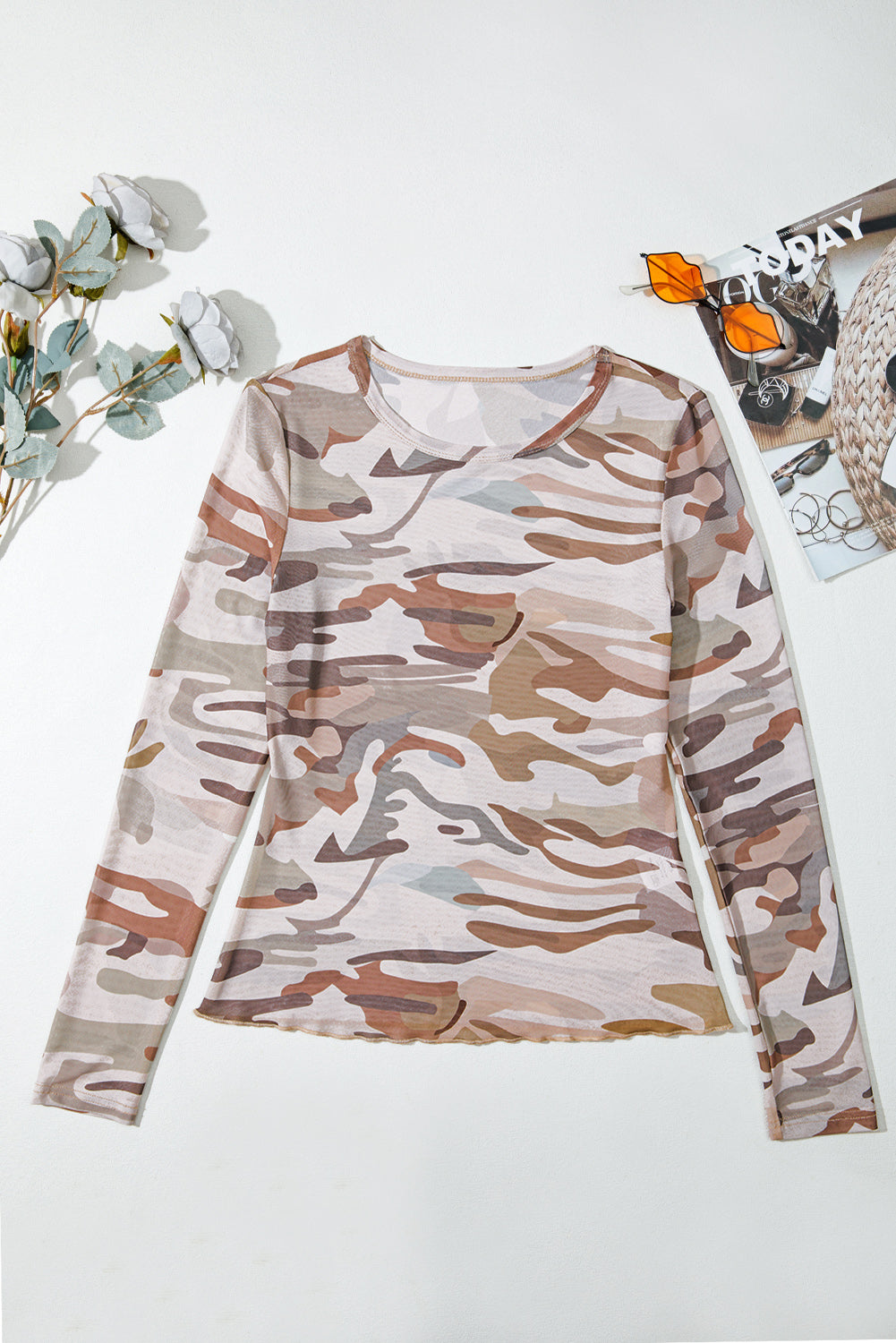 Camouflage long-sleeve shirt front on a white background with decorative elements.