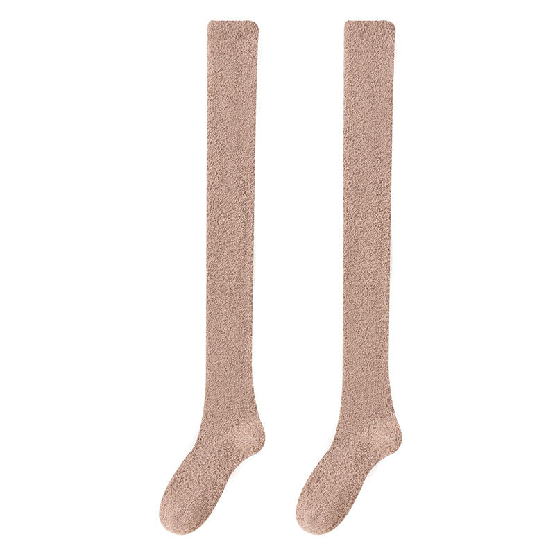 Pair of beige knee-high socks on a white background