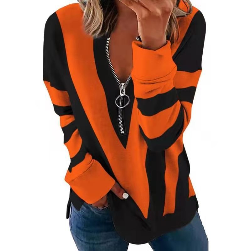 Orange and black striped sweater with a zipper on a white background