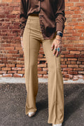 A model wearing Stylish women's High-Waist Parchment Pants and a brown satin button-up shirt.