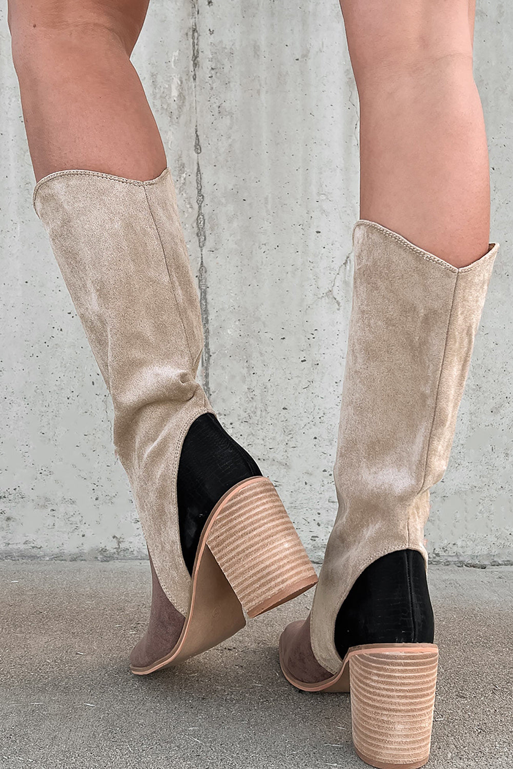 Beige knee-high boots with black accents back view