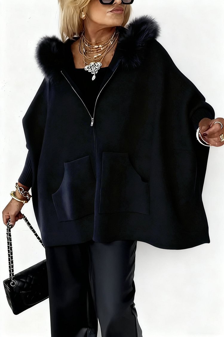 Person wearing a black coat with fur hood on a white background