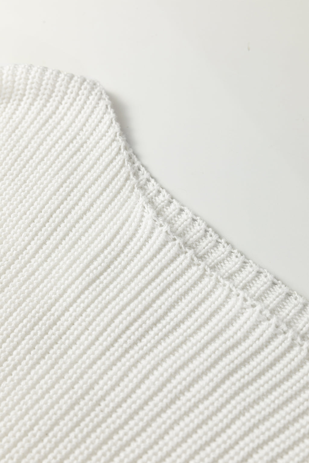 Close-up of a white Asymmetric Neck Drop Shoulder Baggy Sweater.