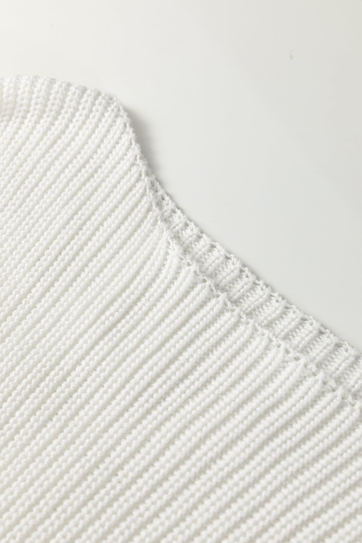 Close-up of a white Asymmetric Neck Drop Shoulder Baggy Sweater.