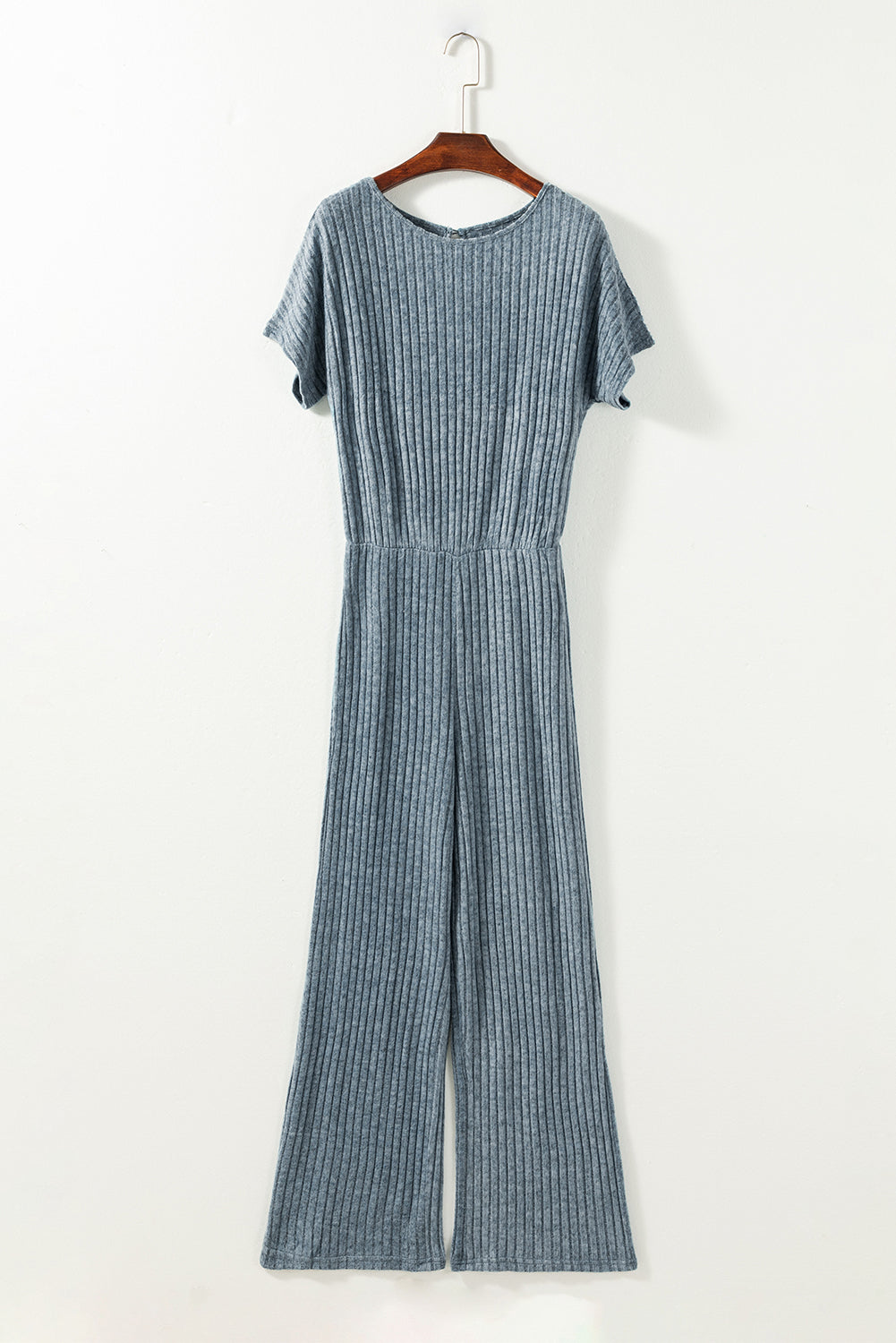 Blue and white striped jumpsuit on a hanger against a white background