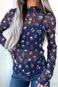 A woman wearing a Chic Women's Blue Polka Dot Floral Sheath Top with a navy blue base and a colorful floral print, paired with blue jeans.