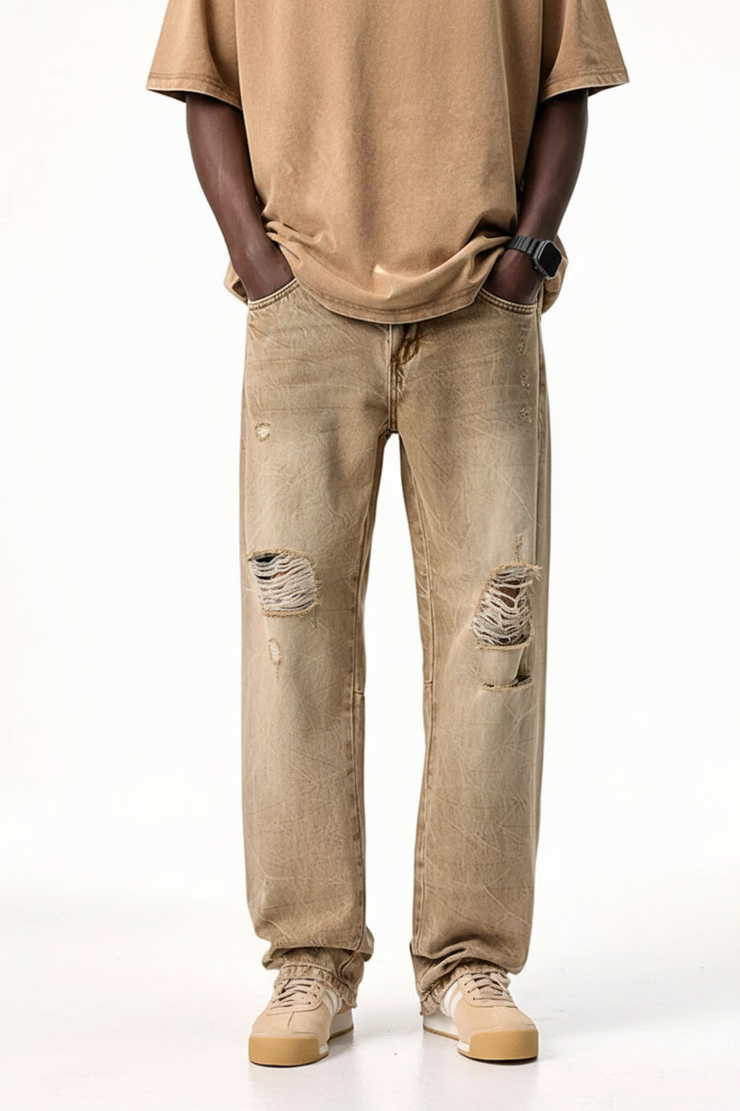 Male model wearing a pair of Men's Camel Brown Distressed Relaxed Fit Jeans