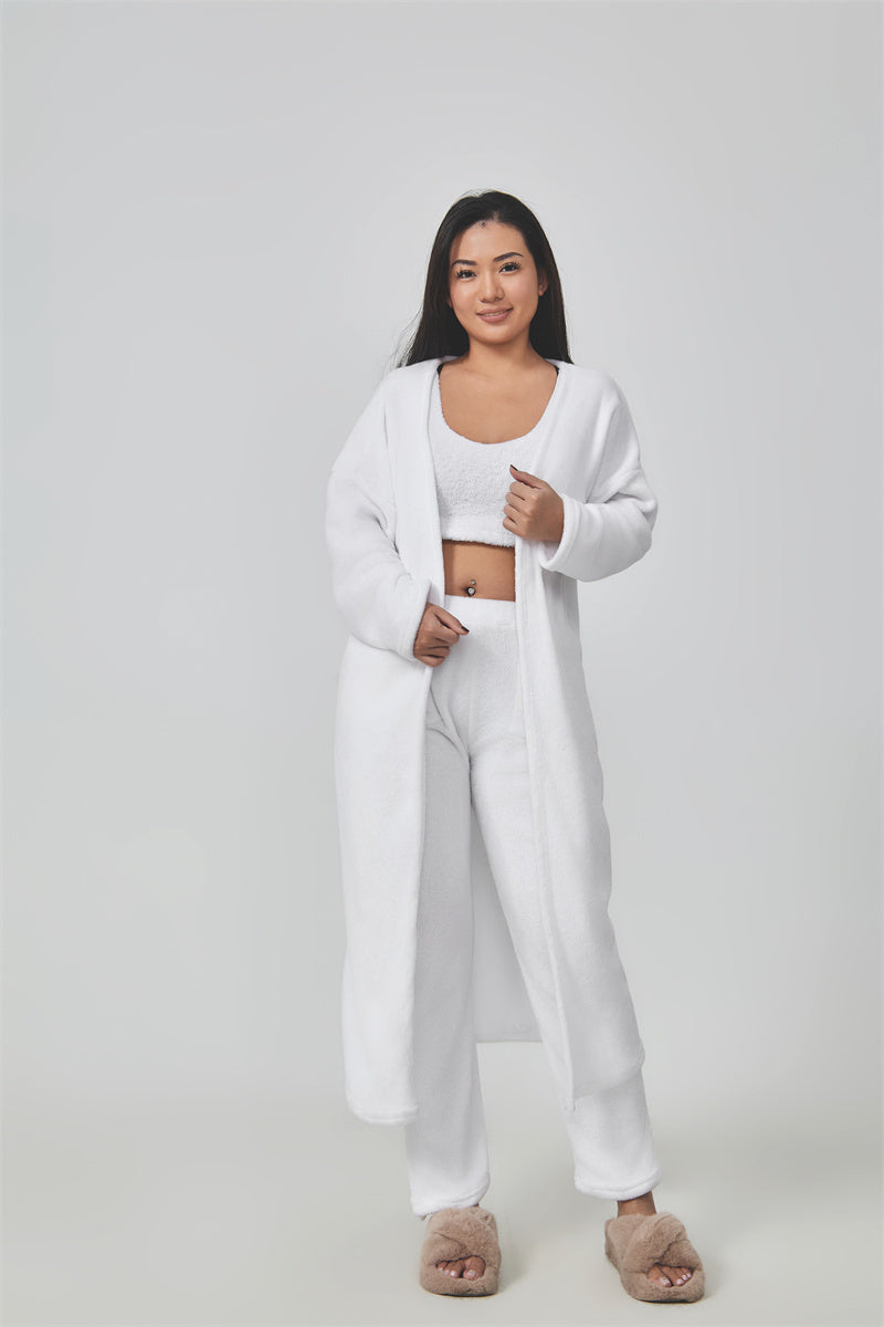 Woman wearing a white outfit on a plain background