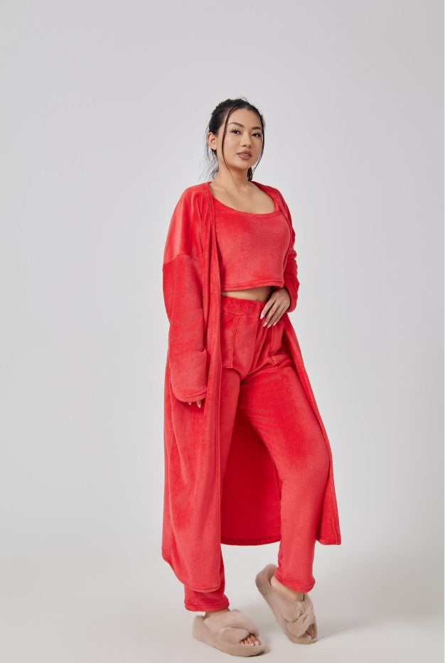 Woman wearing a red outfit with a matching jacket on a white background
