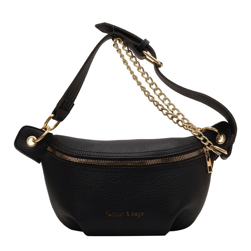 Black waist bag with gold chain strap on a white background