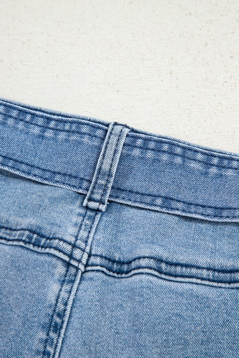 Close-up of blue denim fabric with a white background