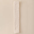 Rectangular white bar with textured surface on a beige background