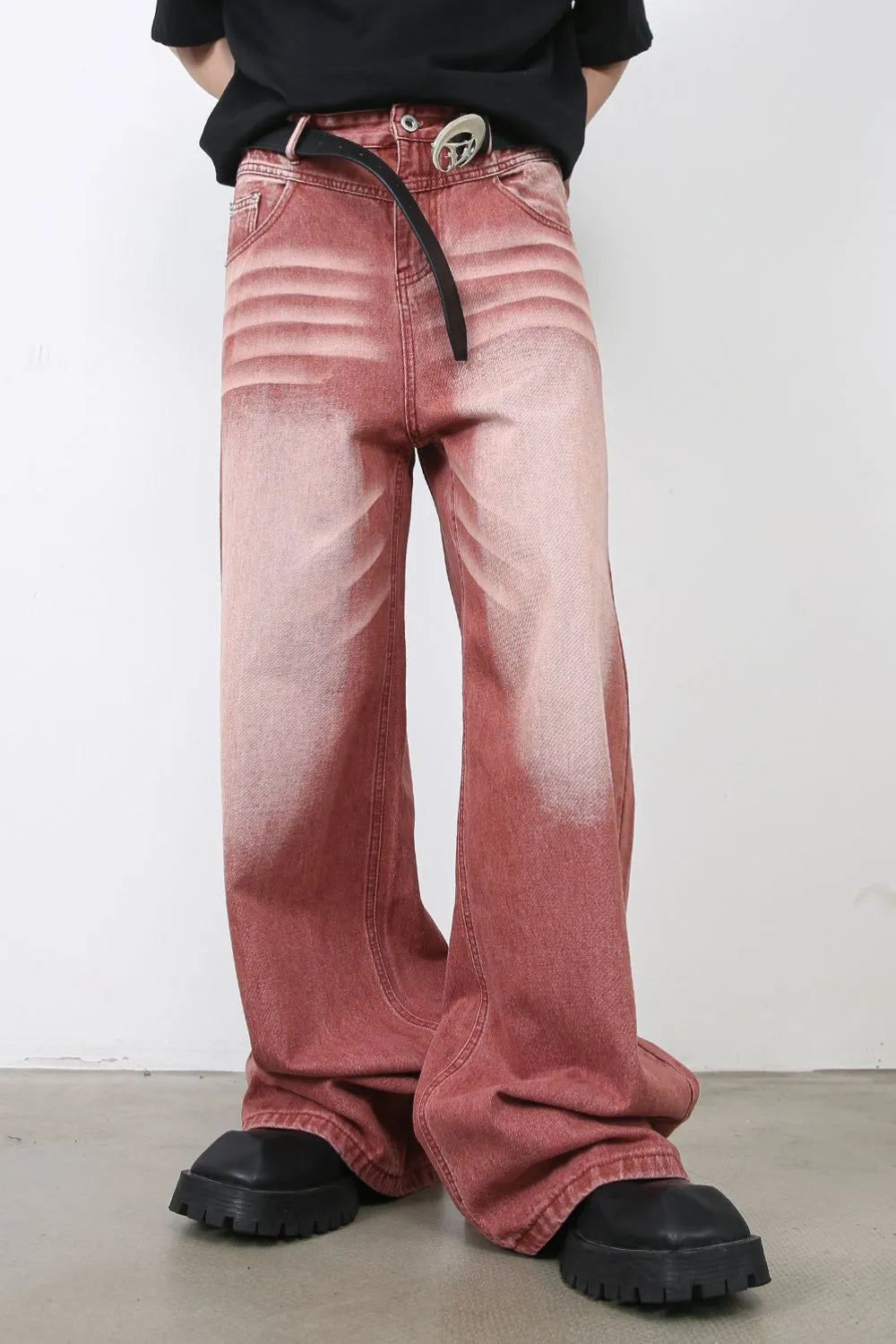 Person wearing rust red acid washed flared jeans 