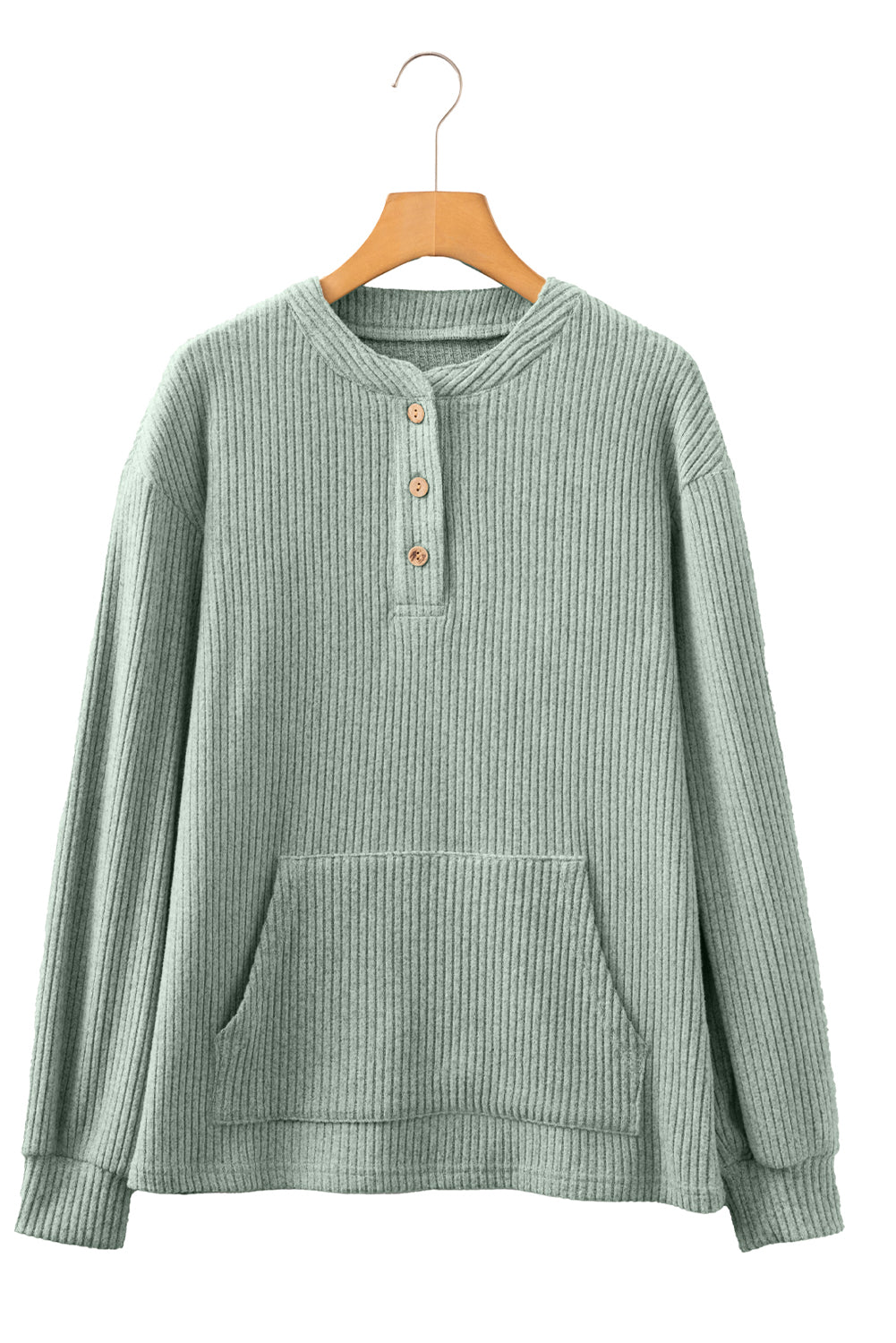 Green ribbed sweater on a wooden hanger against a white background