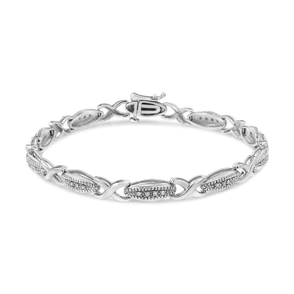 Silver bracelet with intricate design on a white background