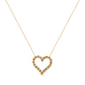 Gold heart-shaped necklace with small stones on a white background
