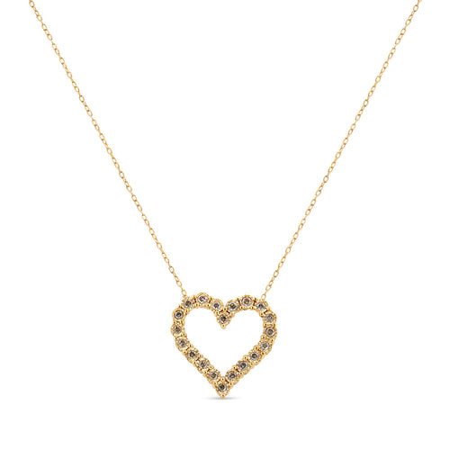 Gold heart-shaped necklace with small stones on a white background