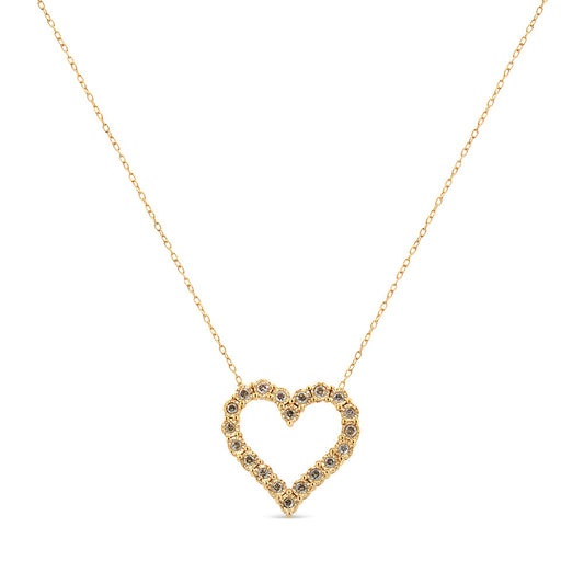 Gold heart-shaped necklace with small stones on a white background
