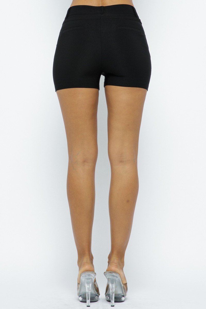 Person wearing black shorts on a white background back view