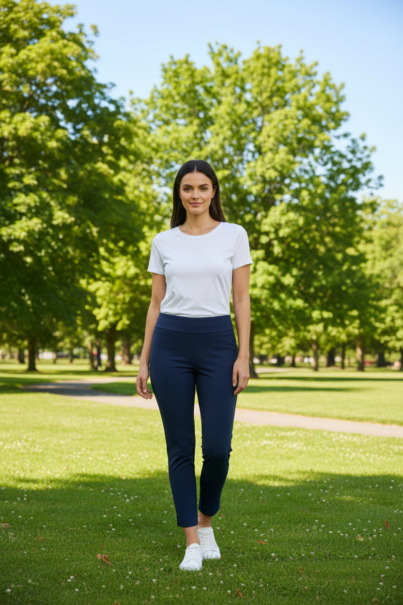 Woman wearing a white t-shirt and navy pants on a white background
