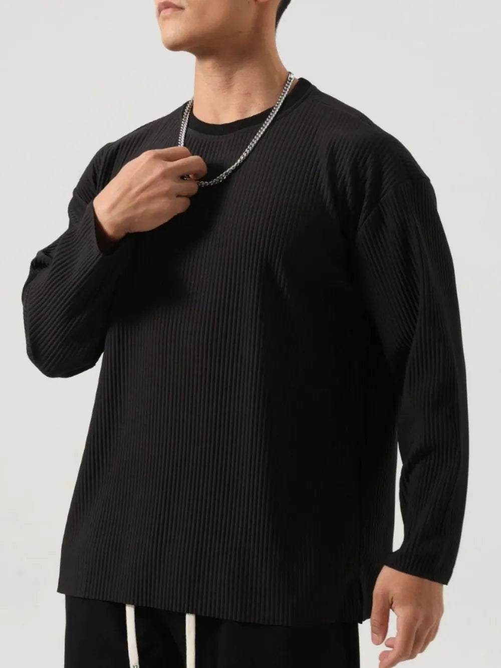 Person wearing a black Men's Basic Ribbed Round Neck Long Sleeve T-Shirt