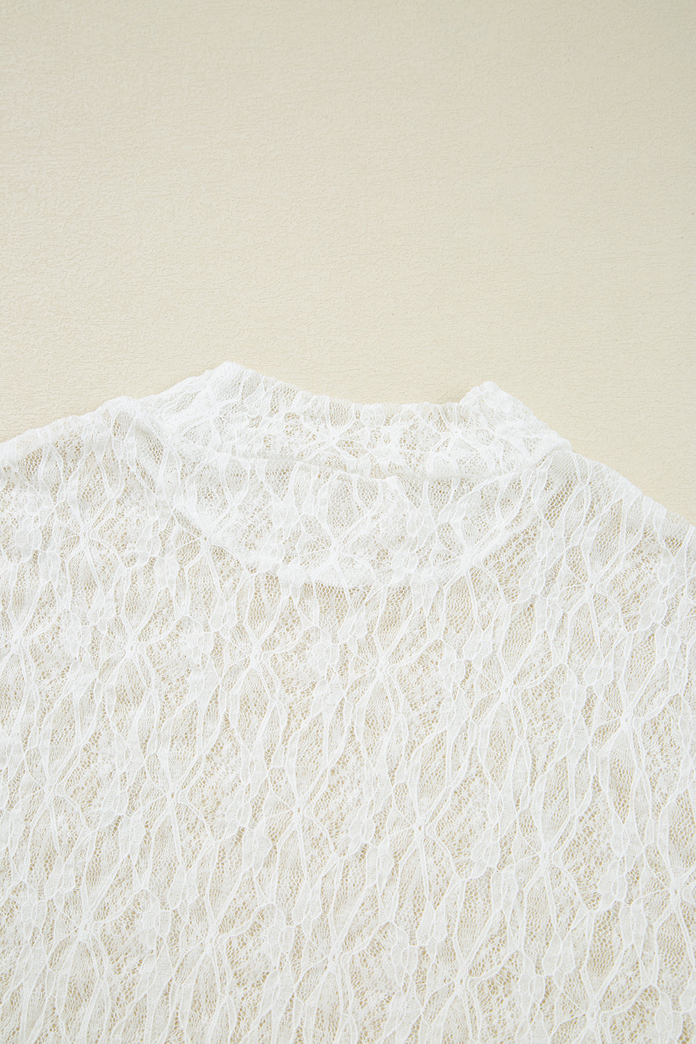 Close-up of a textured white fabric on a beige background